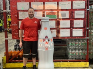 Forklift Operator Spencer Dury with the Recognition Roadtrip Bottle at the Quapah facility on Oct. 25, 2021.