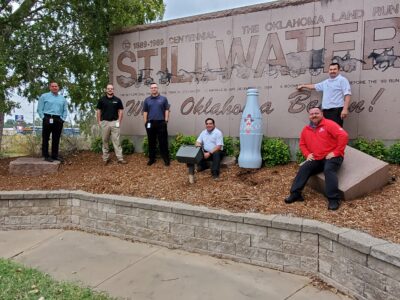 Stillwater Distribution Center Managers and ORMs take the Recognition Roadtrip Bottle to “Where Oklahoma Began” at the official welcome area marked by the Stillwater City Sign on Oct. 20, 2021.