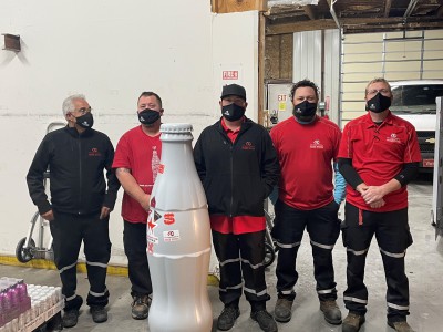 Drivers and Merchandisers add their official Woodward sticker to the Recognition Roadtrip Bottle at the Woodward facility on Oct. 28, 2021.