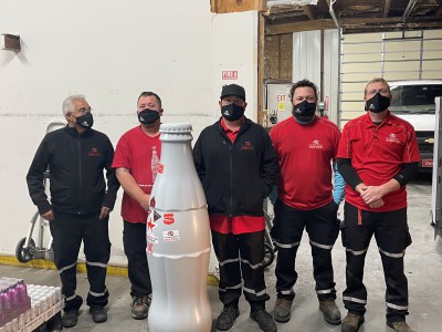 Drivers and Merchandisers add their official Woodward sticker to the Recognition Roadtrip Bottle at the Woodward facility on Oct. 28, 2021.