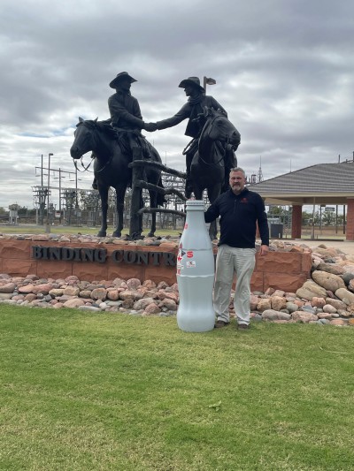 Chris Havel, Distribution Supervisor, in front of the “Binding Contract” statue created by Bradford J. Williams - who specializes in Western sculptures. Woodward has 17 similar bronze statues located around the city.