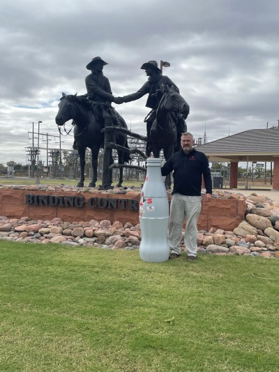 Chris Havel, Distribution Supervisor, in front of the “Binding Contract” statue created by Bradford J. Williams - who specializes in Western sculptures. Woodward has 17 similar bronze statues located around the city.