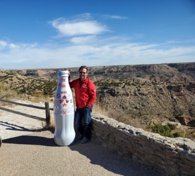 Justin Sexton, Route Sales Manager, with the Recognition Roadtrip Bottle at Palo Duro Canyon on Nov. 17, 2021. The 30,000 acres of Palo Duro Canyon are home to the endangered Texas Horned Lizard and thousands of other species.