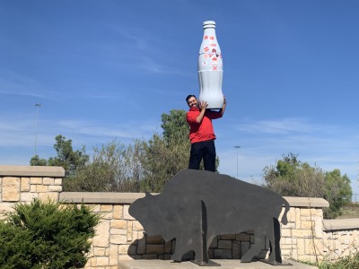 Tim Miranda, Sales Execution Manager, in front of an American Bison statue with the Recognition Roadtrip Bottle on Nov. 8, 2021. Once an endangered species, the American Bison population has grown from less than 1,000 to over 500,000.