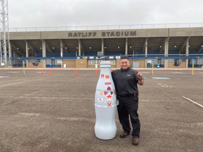 Jesse Quezada, Area Sales and Merchandising Manager, at Odessa’s Ratliff Stadium with the Recognition Roadtrip Bottle on Nov. 4, 2021. Ratliff Stadium was the featured home stadium in the 2004 classic sports drama, “Friday Night Lights.”