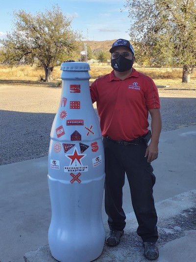 George Mendoza, Driver Merchandiser, with the Recognition Roadtrip Bottle in Alpine, Texas on Nov. 30, 2021. Surrounded by mile high mountain peaks, Alpine is the one of the highest cities in Texas with an elevation of 4,475 feet.