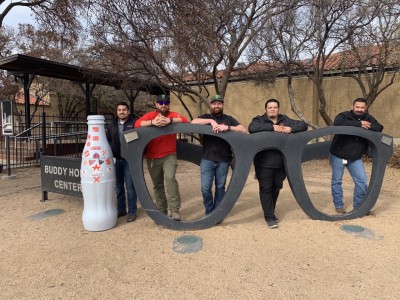 Lubbock heroes with the Recognition Roadtrip Bottle at the Buddy Holly Center on Dec. 9, 2021. Famous for his horn-rimmed glasses and pioneering Rock and Roll, musician Buddy Holly was born and raised in Lubbock, Texas.