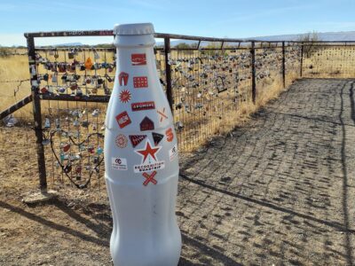 The Recognition Roadtrip Bottle near the Prada Marfa sculpture where visitors “mark” their presence on the surrounding fence with locks, crosses and handcuffs.