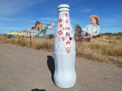 The Recognition Roadtrip Bottle posing with giant plywood artwork which pays tribute to the 1956 James Dean and Liz Taylor film, “Giant.” Located on the Ranch where the movie was filmed, the art installation completes the Western country vibe depicted in the feature film.