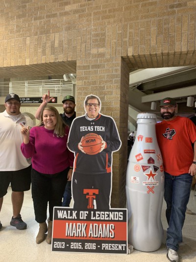 CCSWB Lubbock heroes with the Recognition Roadtrip Bottle and a cut-out of Red Raiders head coach, Mark Adams. The 2021-2022 season marks his first season as head coach of Texas Tech after serving as an assistant coach. Fans are excited to see the Red Raiders battle it out in the nation’s best conference, the Big 12.