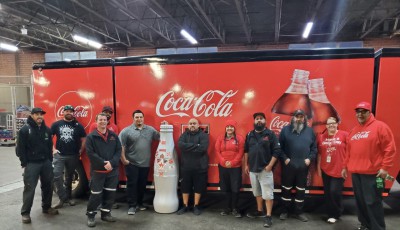 CCSSWB Lubbock heroes say “goodbye” to the Recognition Roadtrip Bottle in front of a Coca-Cola and Texas Tech University trailer at the United Supermarkets Arena on Dec. 9, 2021.