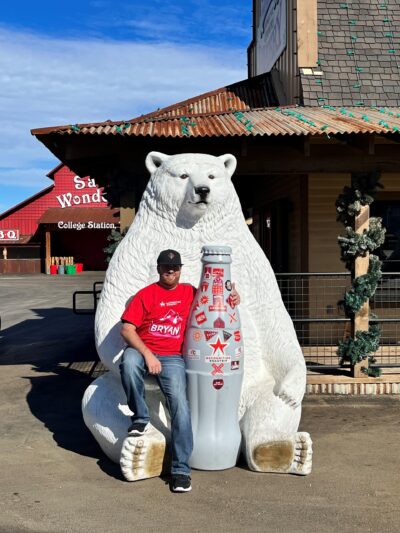 Blake Smith, Distribution Supervisor, chills with the Recognition Roadtrip Bottle and a polar bear at Santa’s Wonderland on Jan. 12, 2022. The Bottle is just the right size for the polar bear to drink from!