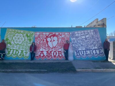 Del Rio heroes with the Recognition Roadtrip Bottle in front of the “Life Love Death” mural in downtown Del Rio on Jan. 3, 2022. The “Life Love Death” mural was created by Gabriella Rosales in 2015.