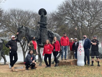 Waco heroes with the bottle at "The Waco Chisholm Trail Heritage" statue near the Waco suspension bridge. This landmark acknowledges the area that served as a rest stop for cattle drivers, Waco’s shallow banks along the Brazos River allowed cattle to cross the river safely.