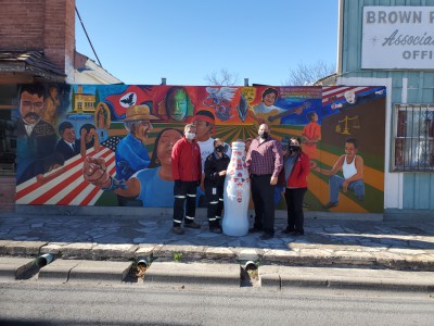Del Rio heroes with the Recognition Roadtrip Bottle in front of the “Memories” mural in downtown Del Rio on Jan. 3, 2022. This mural, created by Raul Valdes & Chris Escobar, depicts memories of growing up on the Mexico-U.S. border.