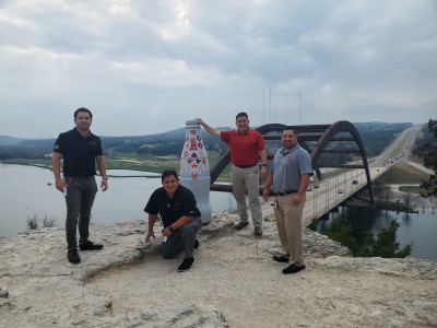 Austin heroes overlook the Pennybacker Bridge with the Recognition Roadtrip Bottle on Dec. 30, 2021. The Pennybacker Bridge was built in 1982 and suspends over Lake Austin connecting the northern and southern sections of Austin.