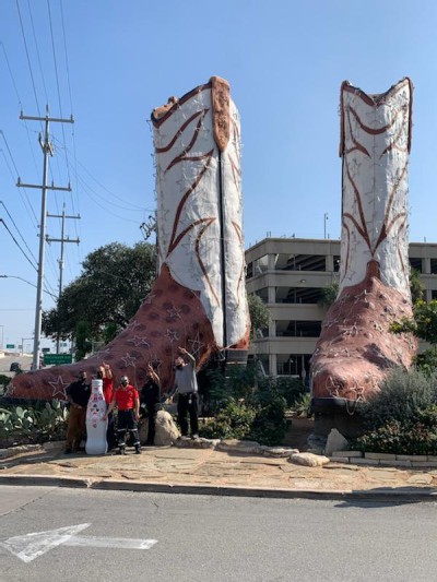 San Antonio heroes say “goodbye” to the Recognition Roadtrip Bottle at the “World’s Largest Cowboy Boots” on Dec. 31, 2021. Created by Bob "Daddy-O" Wade, the pair of humongous fake ostrich-and-calf-skin cowboy boots stand 35 feet tall and 33 feet long.