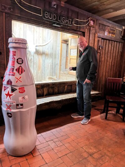 Pat Patrick, Sales Center Manager introduces Sneaky Snake to the Recognition Roadtrip Bottle on Jan 12, 2022. Sneaky Snake is Dixie Chicken’s pet rattlesnake and has a spacious encloser within the Dixie Chicken bar.