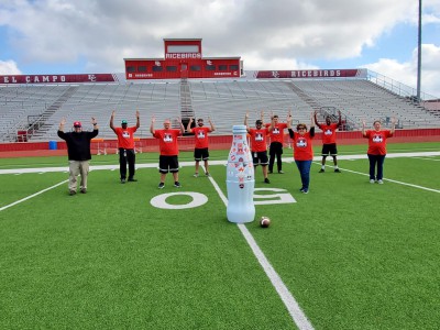 El Campo heroes with the Recognition Roadtrip Bottle at Ricebird Stadium on Jan. 6, 2022. Opened in 1946, Ricebird Stadium is home of the El Campo High School Ricebirds and has a max capacity of 5,412