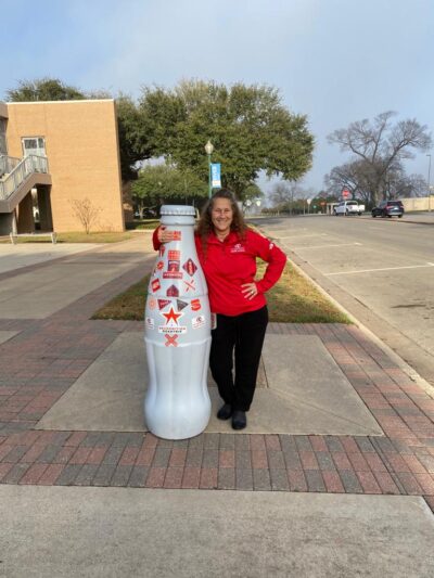 Rhonda Dunahoo, Business Manager, with the Recognition Roadtrip Bottle at the Waco Convention Center on Dec. 21, 2021.