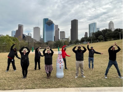Coca-Cola in the Bayou! CCSWB Northpoint heroes spell out the iconic drink name as they show the Recognition Roadtrip Bottle off in Buffalo Bayou Park on Jan. 11, 2022. The 160-acre park is one of the best places in Houston to see the city skyline, as well as varied activities for visitors – including experiencing one of Houston’s first underground drinking-water reservoirs, hiking and viewing the bat colony at Waugh Bridge.