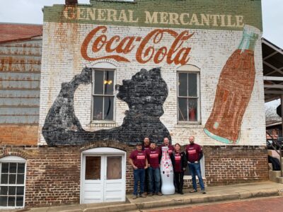Nacogdoches heroes take the Recognition Roadtrip Bottle on a throwback journey to the Nacogdoches General Mercantile on Jan. 20, 2022. The store still uses its 1890s cash register, so you can buy your ice-cold Coca-Cola the same way people have done for the last 125 years.