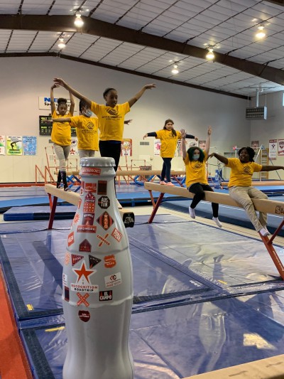 The Recognition Roadtrip Bottle practices its balancing act with the Boys and Girls Club of Nacogdoches on Jan. 20, 2022. The Boys and Girls Club of Nacogdoches opened its doors in 1989 and has served thousands of children in the 30+ years since.