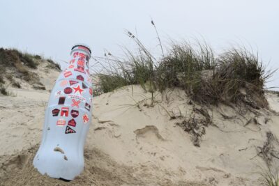 The Recognition Roadtrip Bottle catches some rays at the beach on South Padre Island on March 9, 2022. The beach is near the Laguna Madre Bay, one of six hyper-saline bays in the world with salt content higher in the bay than the rest of the ocean. This is crucial for sea life in the Gulf of Mexico – and fun for visitors, who will float better in the water!