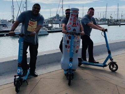 The Recognition Roadtrip Bottle goes for a spin along the water’s edge with Blue Duck scooters on March 14, 2022.