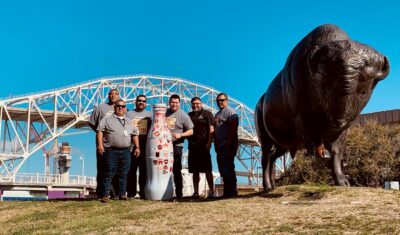 Corpus Christi heroes stopped by the Running Bison statue in front of the Harbor Bridge on March 14, 2022. The bronze sculpture was designed by local artist Kent Ulberg, who is known to only sculpt animals he’s seen and observed first-hand to preserve authenticity.