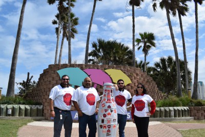 McAllen heroes with the Recognition Roadtrip Bottle on South Padre Island on March 9, 2022.