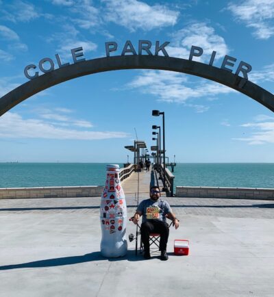 Corpus Christi hero, Jorge Torres, Sales Execution Manger, with the Recognition Roadtrip Bottle at Cole Park Pier on March 14, 2022.