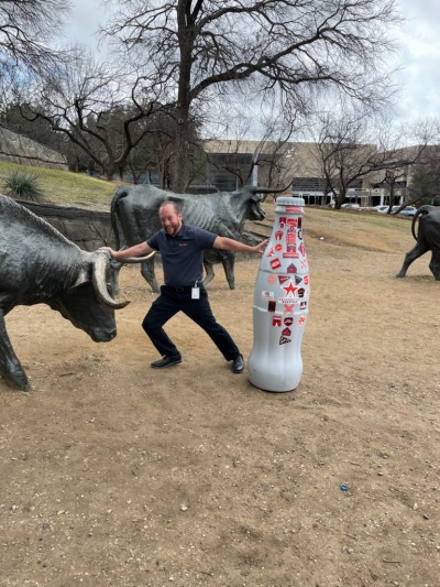 Mesquite hero John Santiago, Small Store Execution Manager, wrangles the bull and the Recognition Roadtrip Bottle at the Pioneer Plaza in Downtown Dallas.