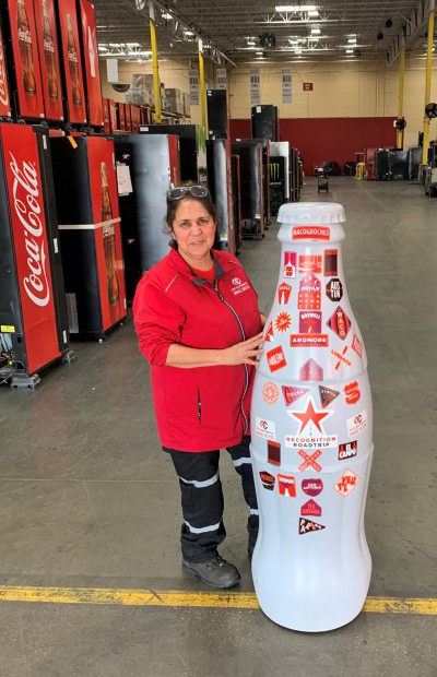 EFC hero, Lettie Garcia, Technician, with the Recognition Roadtrip Bottle on Feb. 22, 2022.