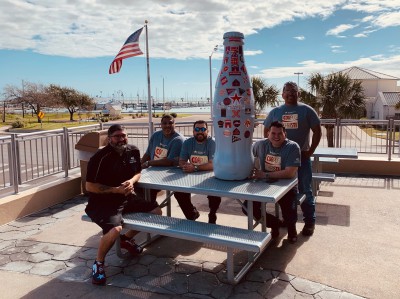 Corpus Christi heroes stop for a bite to eat with the Recognition Roadtrip Bottle at the “Whataburger by the Bay” on March 14, 2022.