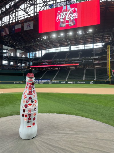 Play ball! The Recognition Roadtrip Bottle prepares to throw the first pitch on the pitcher’s mound of Globe Life Field on March 22, 2022. Fun fact: the distances from home plate to the outfield walls are designed to honor five former Texas Rangers players whose numbers have been retired by the club.