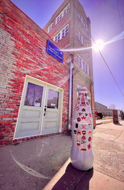 The Recognition Roadtrip Bottle in front of the World’s Smallest Skyscraper on March 28, 2022. After locals realized the measurement mishap that occurred during the building’s construction, builder JD McMahon left the area with no indication of how much money he pocketed or how many investors he had swindled. He was never seen in the area again.