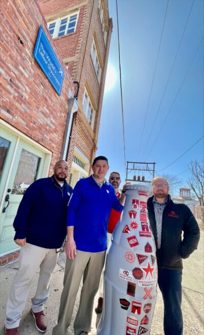 Wichita Falls heroes take the Recognition Roadtrip Bottle to see the World’s Smallest Skyscraper located in downtown Wichita Falls. The building, completed in 1919, is forty feet high, ten feet wide and sixteen feet tall – but why so small? As the story goes, the man who built the little skyscraper, JD McMahon, originally promised a unique skyscraper that would be the jewel of Wichita Falls – 40 stories tall, 100 feet long and 160 feet wide. But instead of being built to the square foot…the skyscraper was built to the square inch.