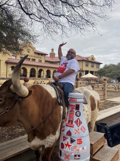 Yeehaw! Fort Worth hero Joe Rios, Special Events Supervisor, takes a ride on the Texas longhorn alongside the Recognition Roadtrip Bottle in the Stockyards on March 22, 2022.