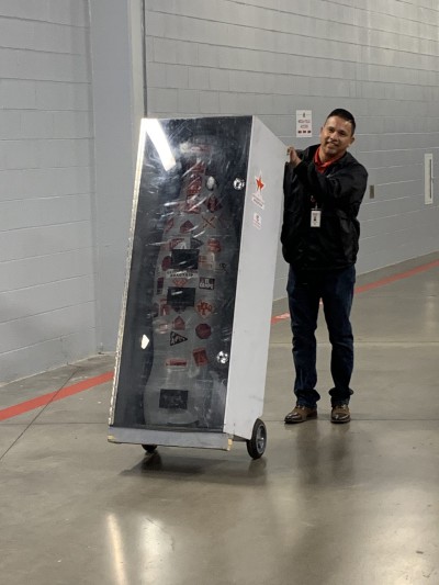 Fort Worth hero Jesse Castro, Sales Execution Manager, loads the Recognition Roadtrip Bottle into its protective case for its trip to the next Fort Worth destination on March 22, 2022.