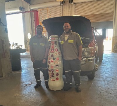 Fleet team members, Ronnie Veigl and Garret Hadsell, with the Recognition Roadtrip Bottle on March 28, 2022.