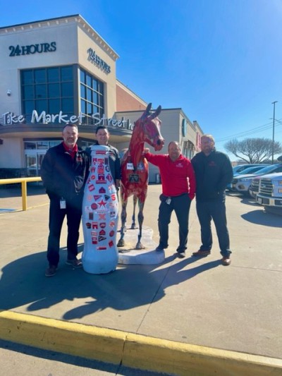 Wichita Falls heroes and the Recognition Roadtrip Bottle share their team “spirit” outside the United Market Street on March 28, 2022. The horse in front of the grocery store, called Spirit, was painted by artist Pam Moller in 2007.