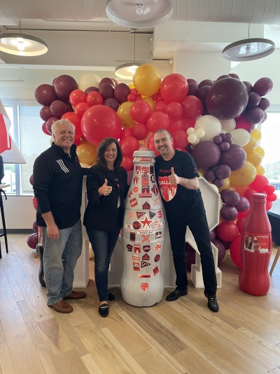 Dallas heroes Debbie Moody, Vice President of Public Affairs & Communications, and Greg Artkop, Director of Communications, with CCSWB president, Jean Claude Tissot and the Recognition Roadtrip Bottle on April 1, 2022.