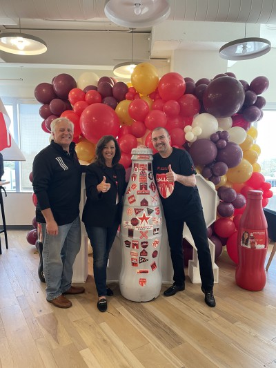 Dallas heroes Debbie Moody, Vice President of Public Affairs & Communications, and Greg Artkop, Director of Communications, with CCSWB president, Jean Claude Tissot and the Recognition Roadtrip Bottle on April 1, 2022.